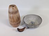 a small bowl and a small vase on a table