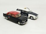 two toy cars sitting next to each other on a white surface