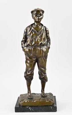 bronze statue of a boy with a hat and pants on a marble base