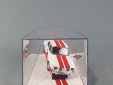 a white and red car in a clear display case