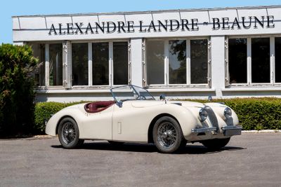 a white car parked in front of a building