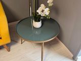 a small table with flowers on it in the corner of a room