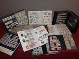 a lot of stamps on a table with a red table cloth