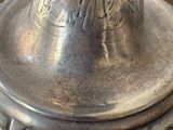 a close up of a silver vase on a table
