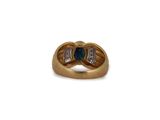 a close up of a gold ring with a blue and white diamond
