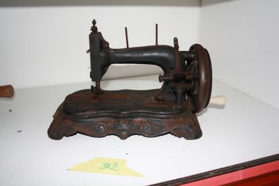 an old sewing machine sitting on a shelf in a room