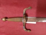a picture of a very old looking sword on a red background