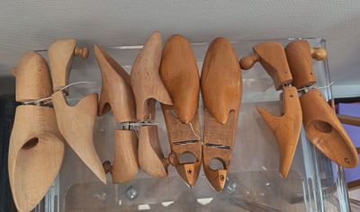 a lot of wooden spoons hanging from a rack