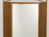 an image of a mirror hanging on a wall with a bamboo frame