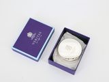 a purple box that has a silver plate inside of it