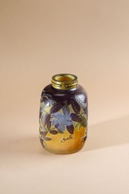 a small glass vase with a floral design on it