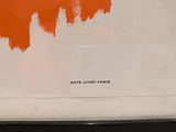 an orange and white painting on a white wall in a room