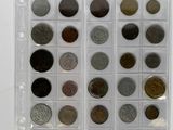 an assortment of coins in a clear plastic case on a white surface