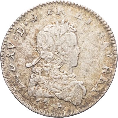 une pièce d'argent sur laquelle figure une femme