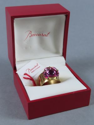 a pink ring in a red box with a red ribbon