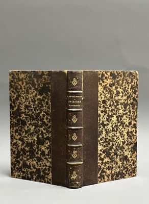 an old book sitting on top of a white table next to a gray wall