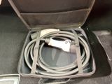 a suitcase with a cable and a charger inside of it