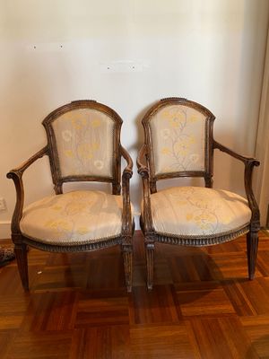 pair of antique carved wood chairs with upholstered upholstered cushions