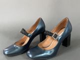 pair of women ' s blue heels with a bow on the heel