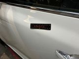 a sticker on the door of a white car