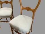 pair of antique carved wood chairs with upholstered upholstered seats