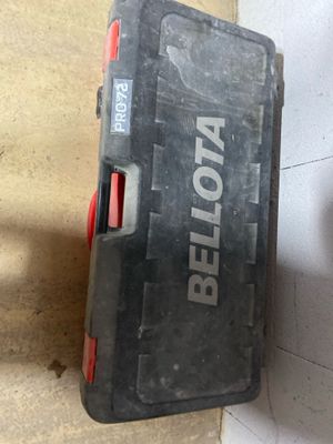 a tool box sitting on the floor next to a pair of scissors