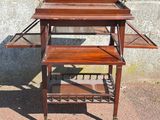 a small wooden table with two shelves on it