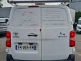 a white van with skis on the back parked in a parking lot