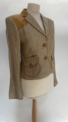 an image of a woman ' s jacket on a mannequin