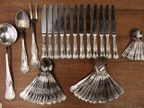 a lot of silverware on a table with spoons and spoons