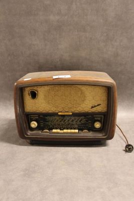 une radio à l'ancienne posée sur une table près d'un mur