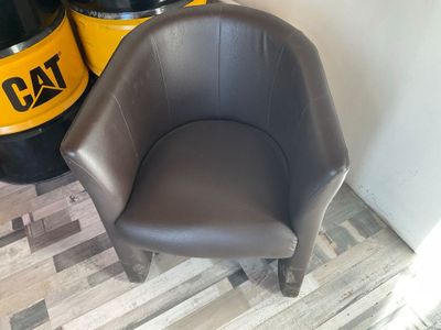 a chair that is next to a barrel of oil