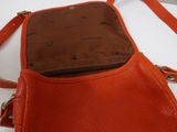 an orange handbag with a brown handle and a brown strap