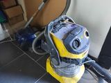 a yellow and black vacuum on the floor in a room