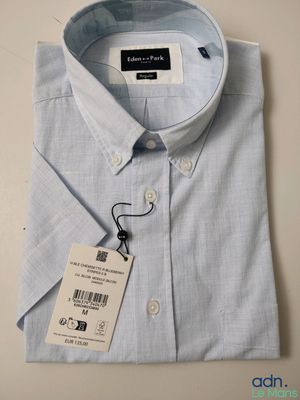 men ' s light blue dress shirt with a tag on the collar