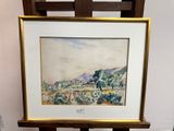 aquarelle encadrée représentant un paysage, posée sur un chevalet en bois