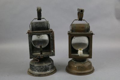 two small metal lanterns sitting on top of each other