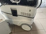 a white and black machine sitting on a tiled floor
