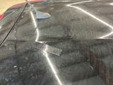 a remote control sitting on the hood of a car