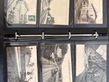 a black binder with a bunch of old photos on it