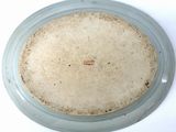 a white plate with a brown label sitting on a table