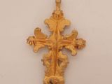 an image of a gold cross on a white surface
