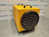 a yellow heater sitting on top of a floor in front of a wall