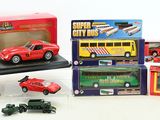 assortment of toy cars and vehicles in boxes on a white surface