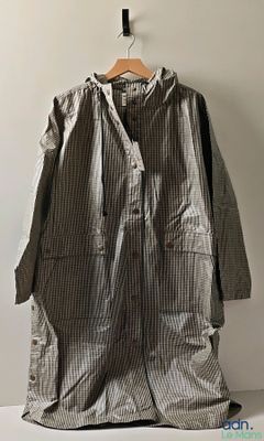 a coat hanging on a hanger on a wall