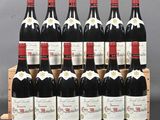 six bottles of red wine are lined up in a wooden crate
