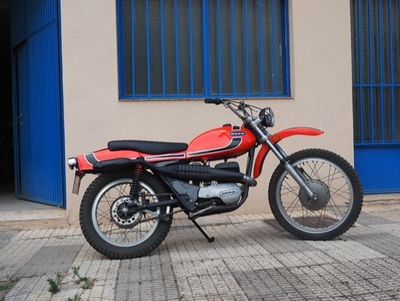 a red motorcycle parked in front of a building