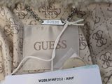 a label on the back of a jacket that says guess