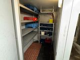 a small room with shelves and shelves in it