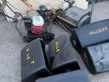 many lawn mowers that are sitting on the ground